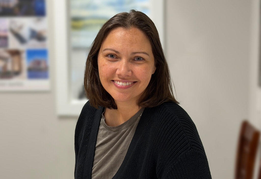 a woman sitting at a table with a plate of food