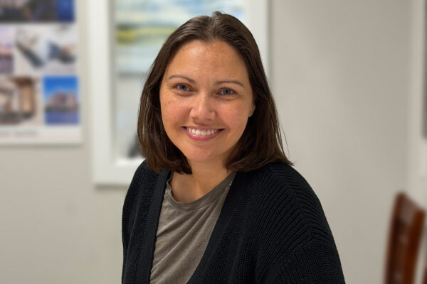 a woman sitting at a table with a plate of food