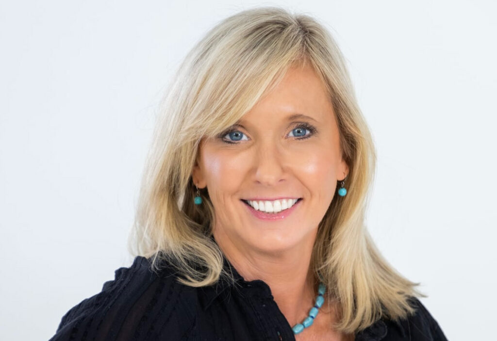 a woman with blonde hair wearing a black shirt