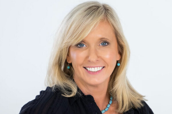 a woman with blonde hair wearing a black shirt