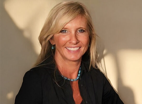 a woman in a black shirt is smiling