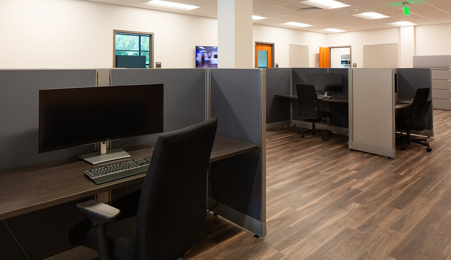 an office cubicle with a desk and computer