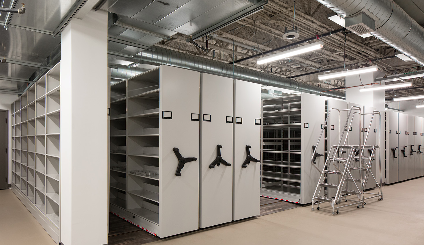a room filled with lots of shelves and ladders