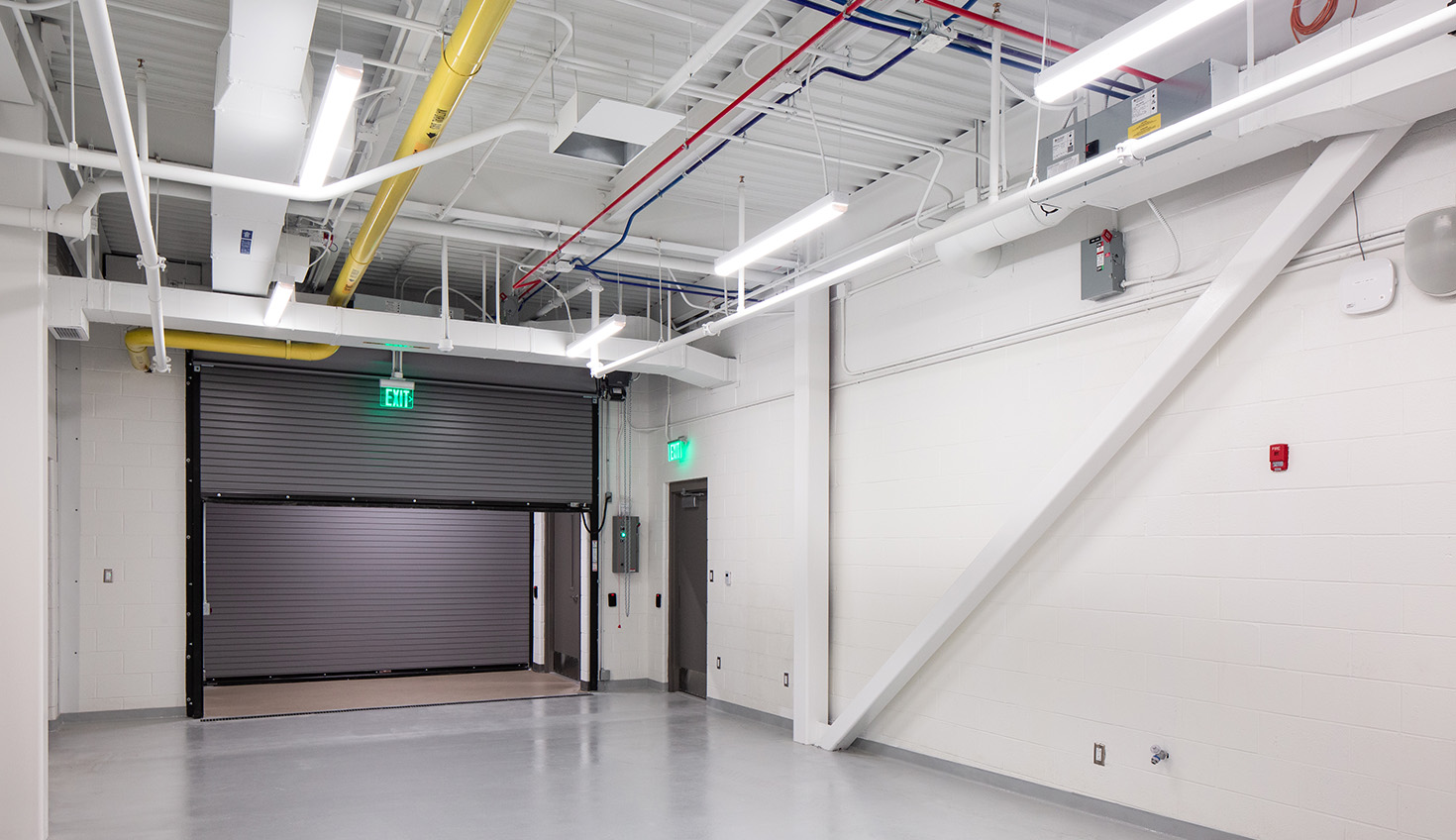a large garage with a door and a fire escape
