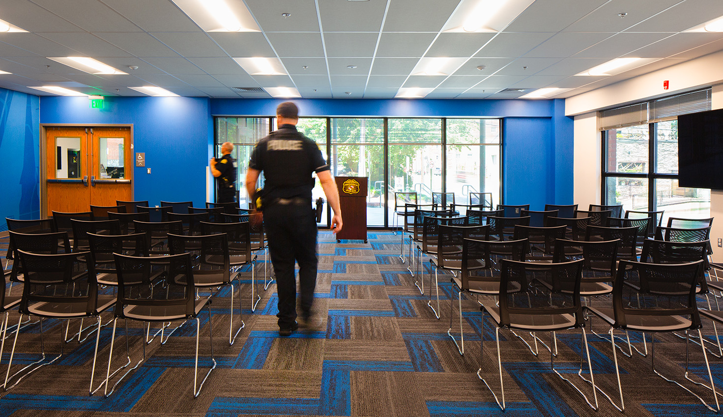 a police officer is walking through a large room