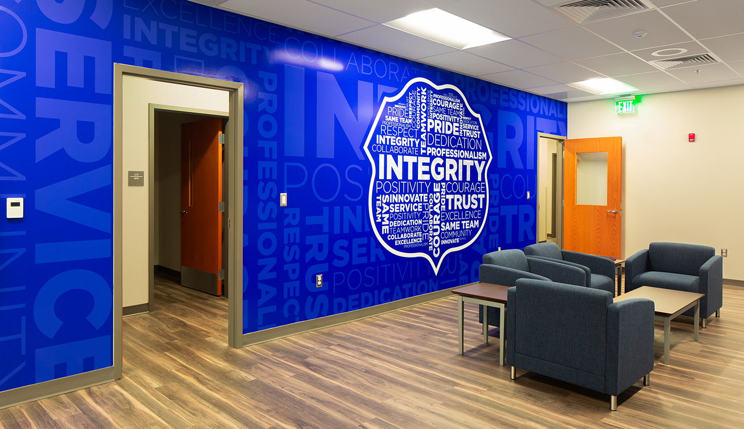 a room with a blue wall and chairs