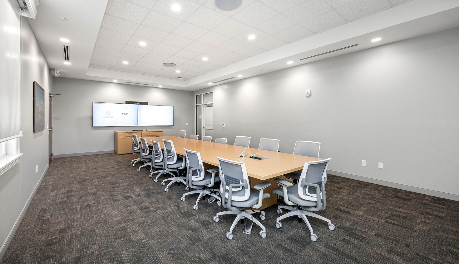 a conference room with a long table and chairs