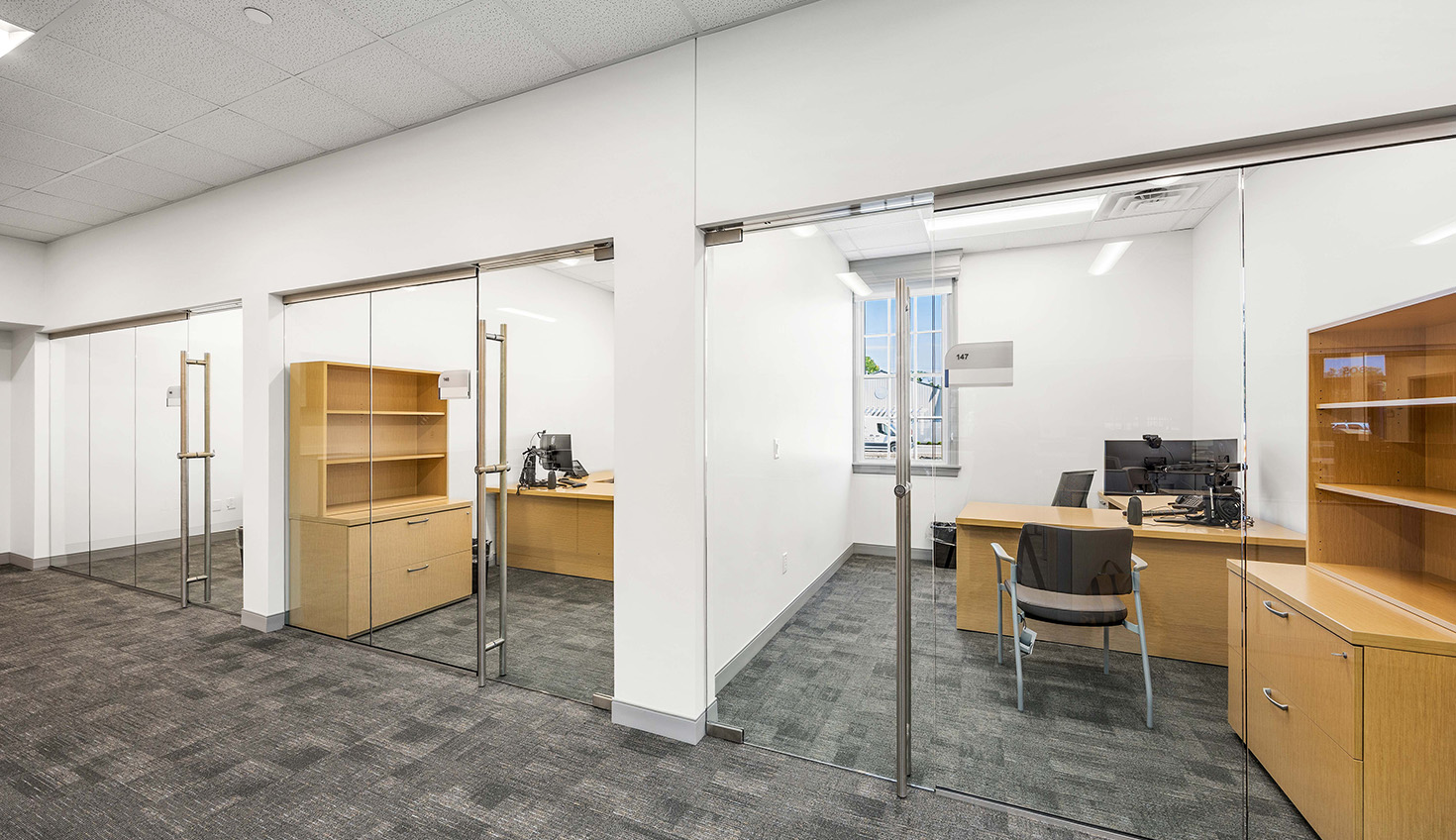 an empty office with a desk and chairs