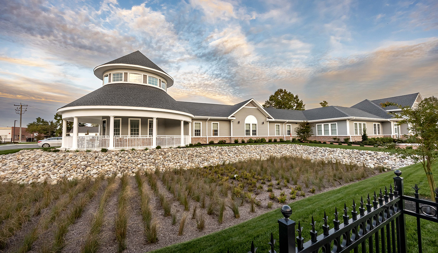 a large white house with a black fence in front of it