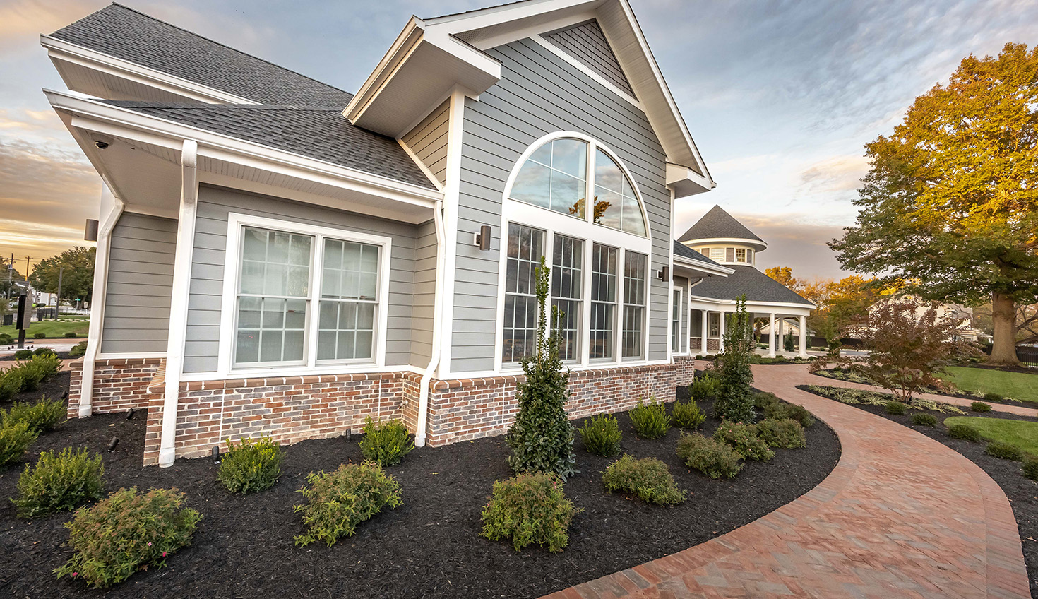 a home with a walkway leading to the front door
