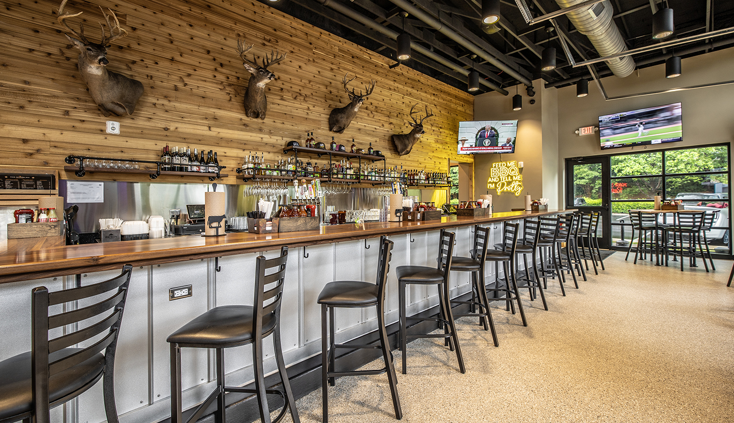 a restaurant with a long bar and lots of chairs